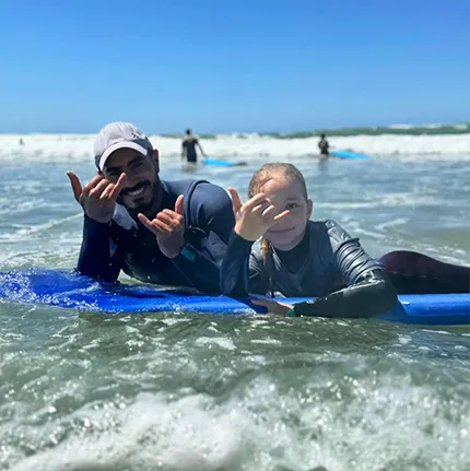 surf lesson with hakim and a young girl in taghazout with elhati surf camp